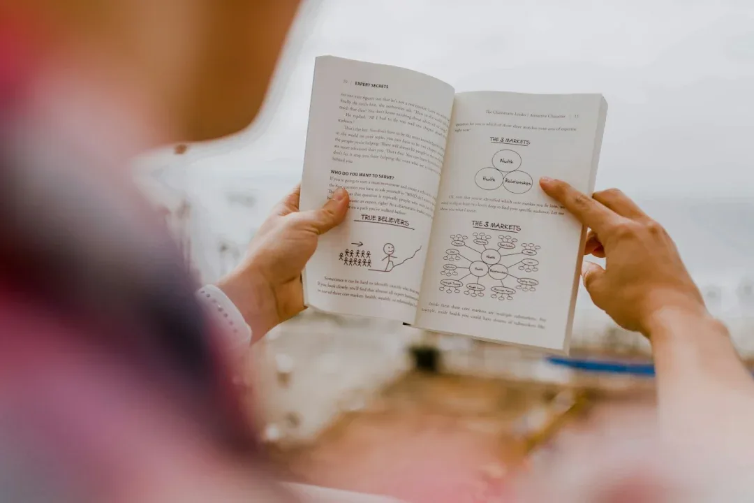 person reading book during daytime