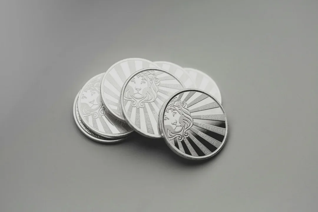 a set of four silver coins sitting on top of a table