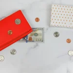 a red wallet and coins