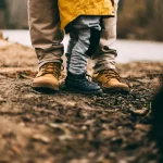 two person step on gray soil